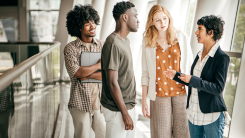 Students listening to a speaker in an office